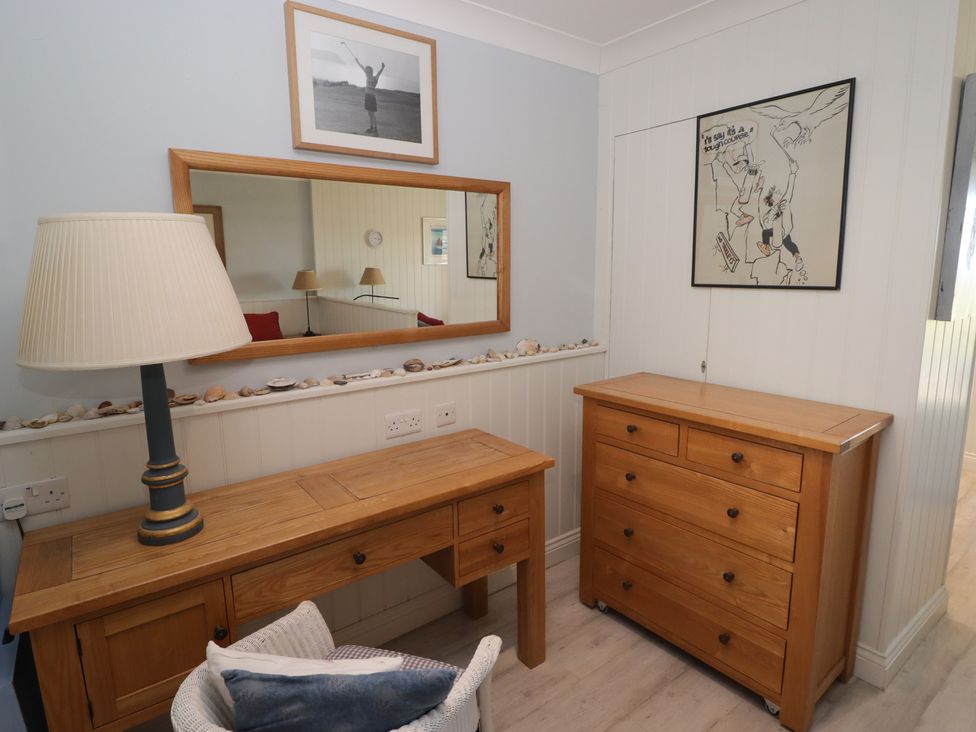 A console table and chest of drawers in a room at The Bolthole in Newport