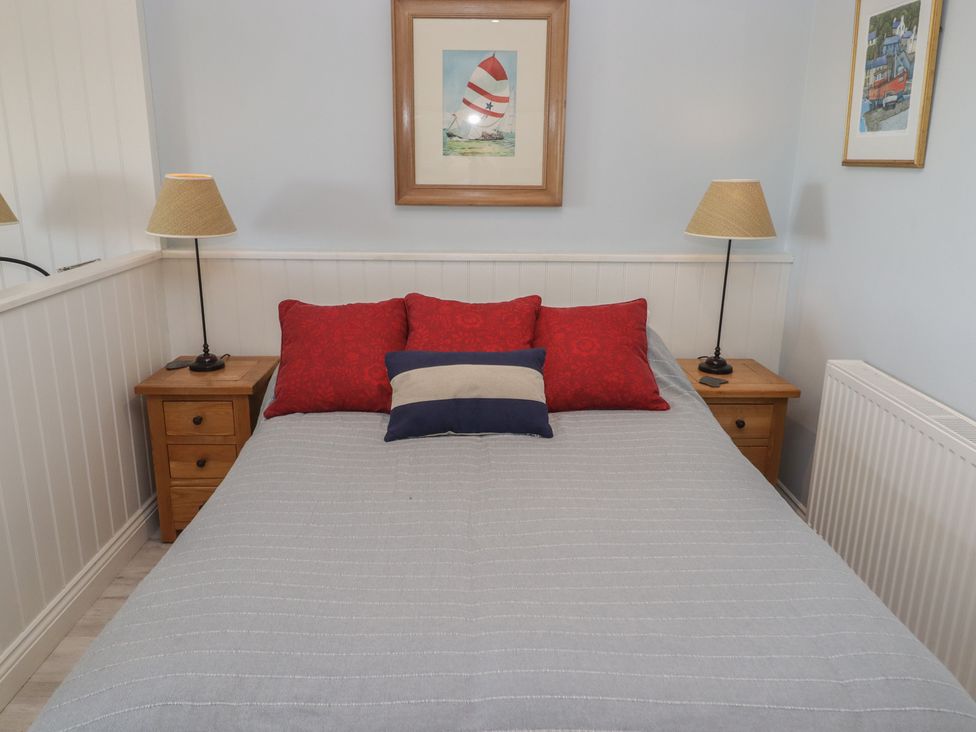 A bedroom with a bed and nightstands at The Bolthole in Newport