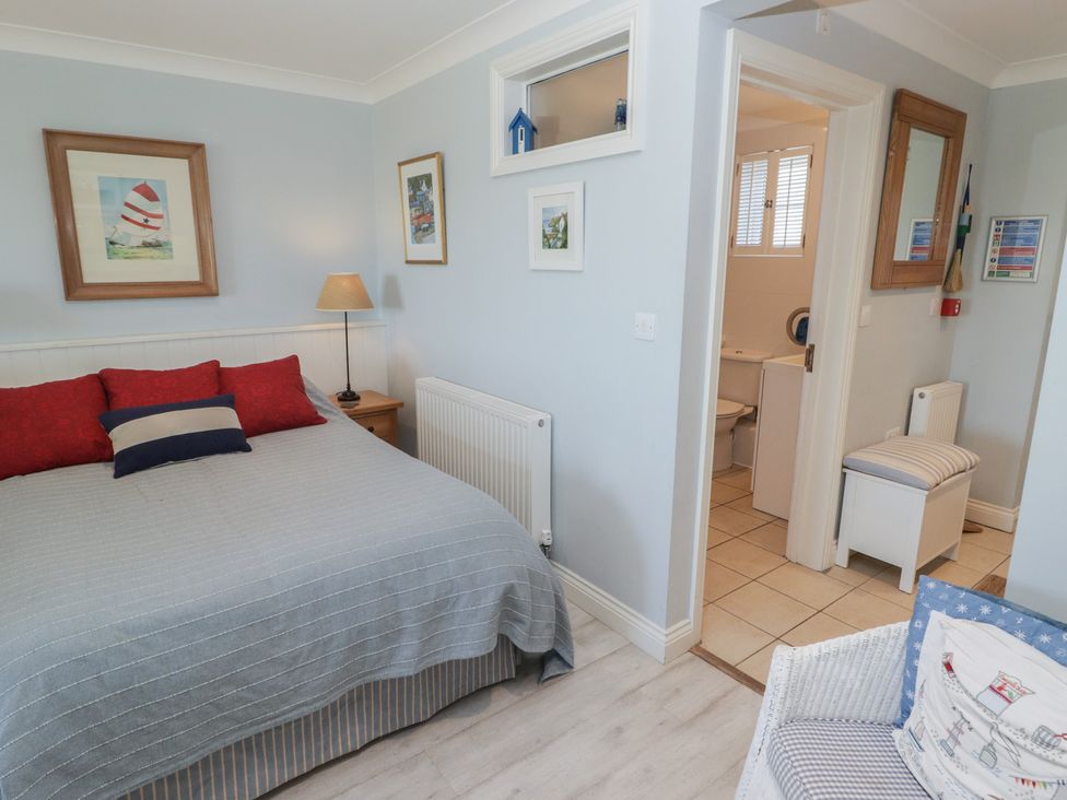 A bedroom with a bed and adjoining bathroom at The Bolthole in Newport