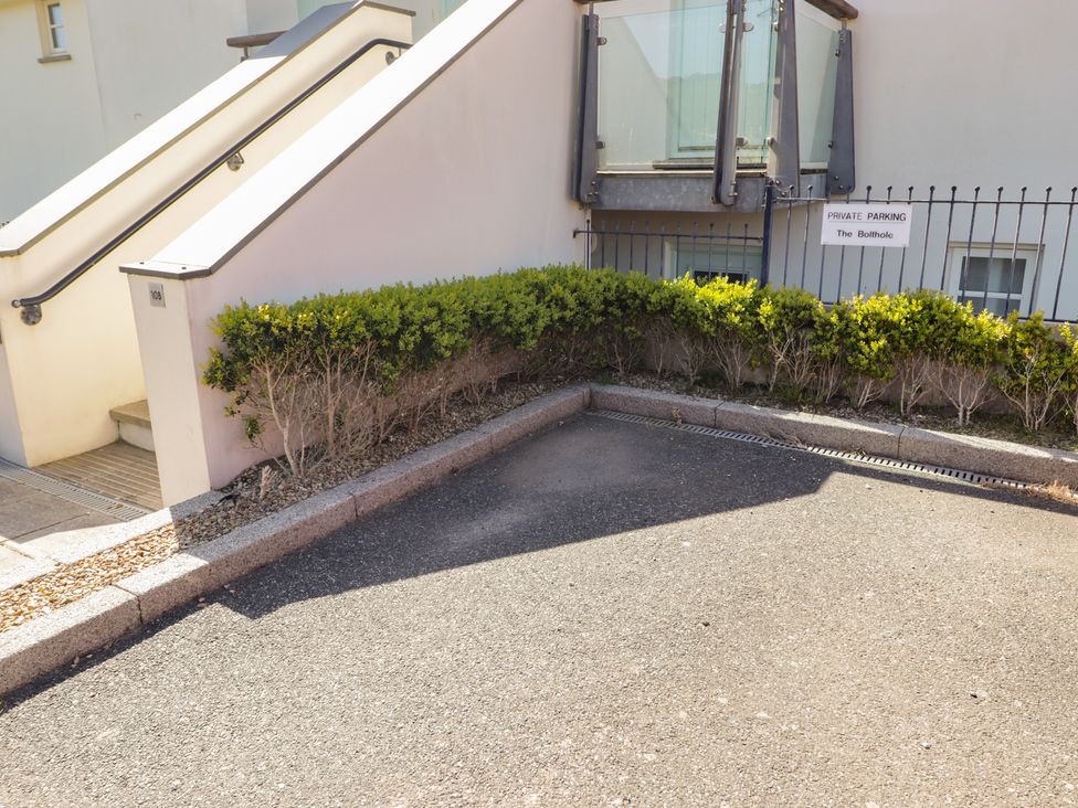A parking area with a staircase and bushes at The Bolthole in Newport