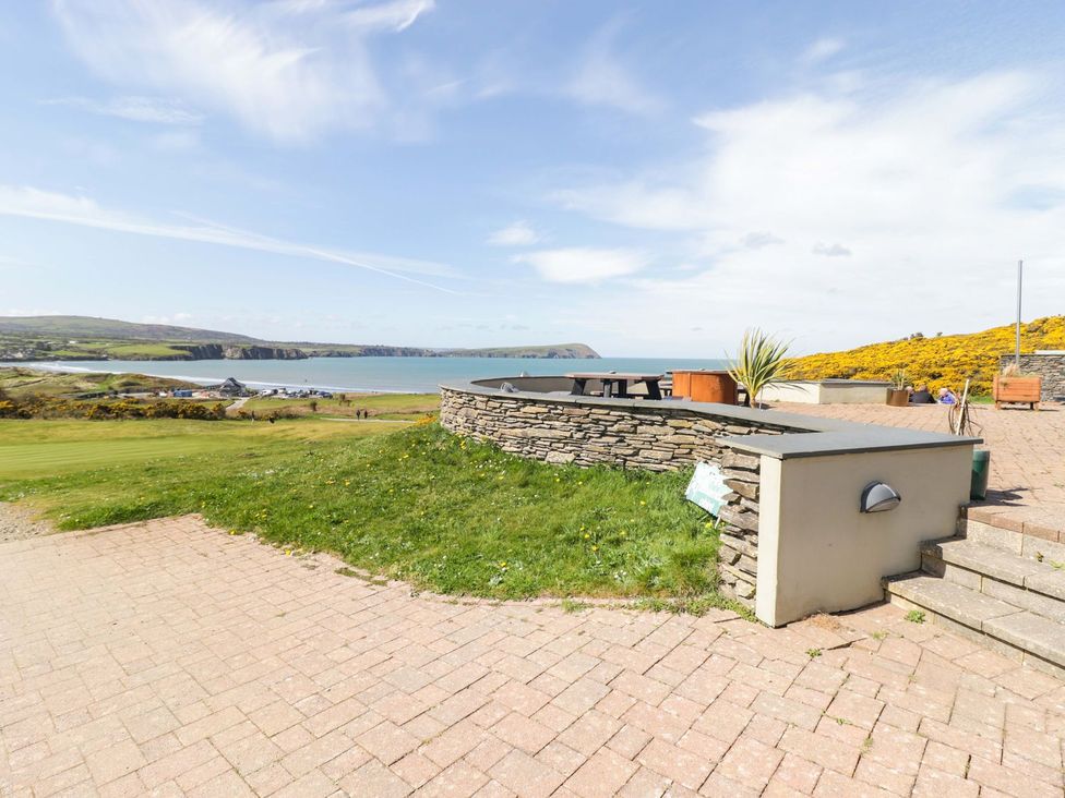 An outdoor area with a stone wall and sea view at The Bolthole in Newport
