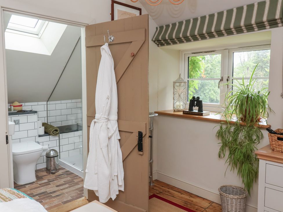 A bathroom with a toilet and sink at The Bothy at Lewis Cottage in Spreyton
