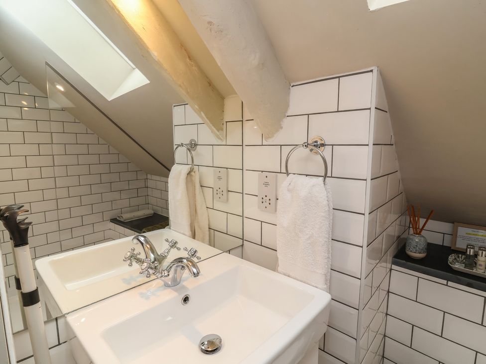 A bathroom with two sinks and towels at The Bothy at Lewis Cottage in Spreyton
