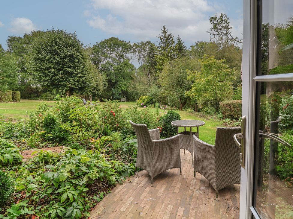 A garden area with a table and chairs at The Bothy at Lewis Cottage in Spreyton