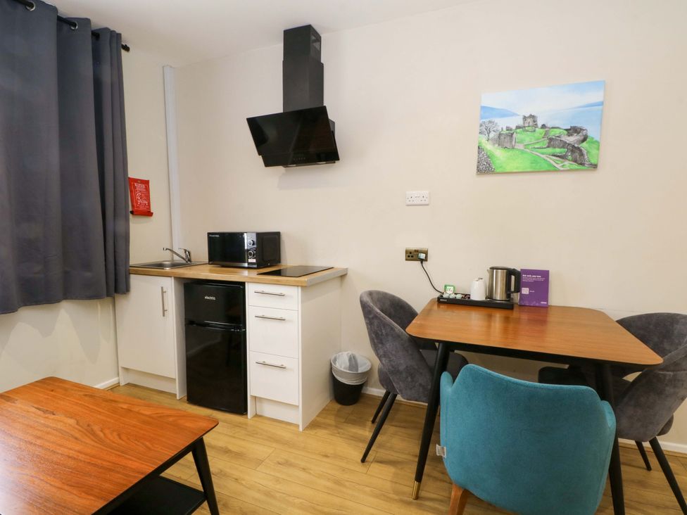 A kitchen with a table and chairs at 2 bed no.1 in Chorley
