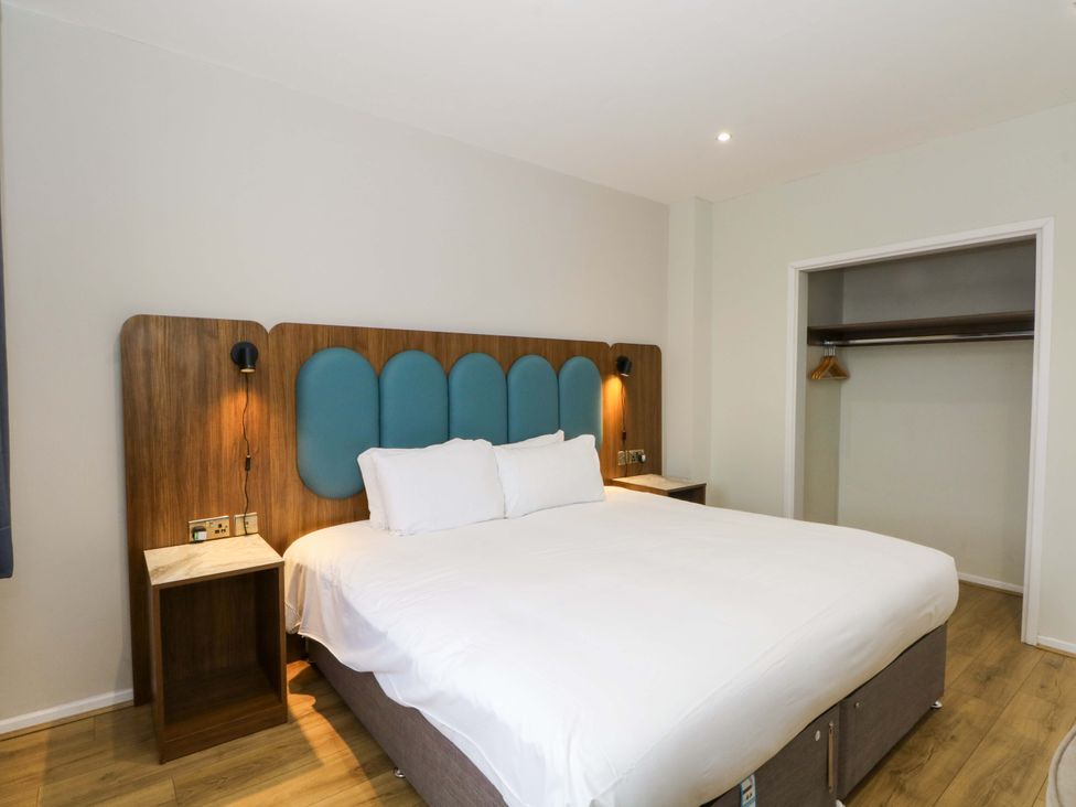 A bedroom with a bed and nightstand at 2 bed no.1 Chorley