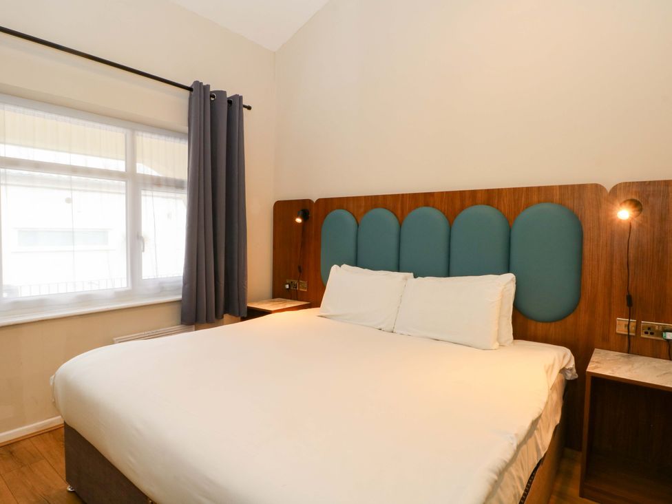 A bedroom with a bed and window at 2 bed no.1 in Chorley