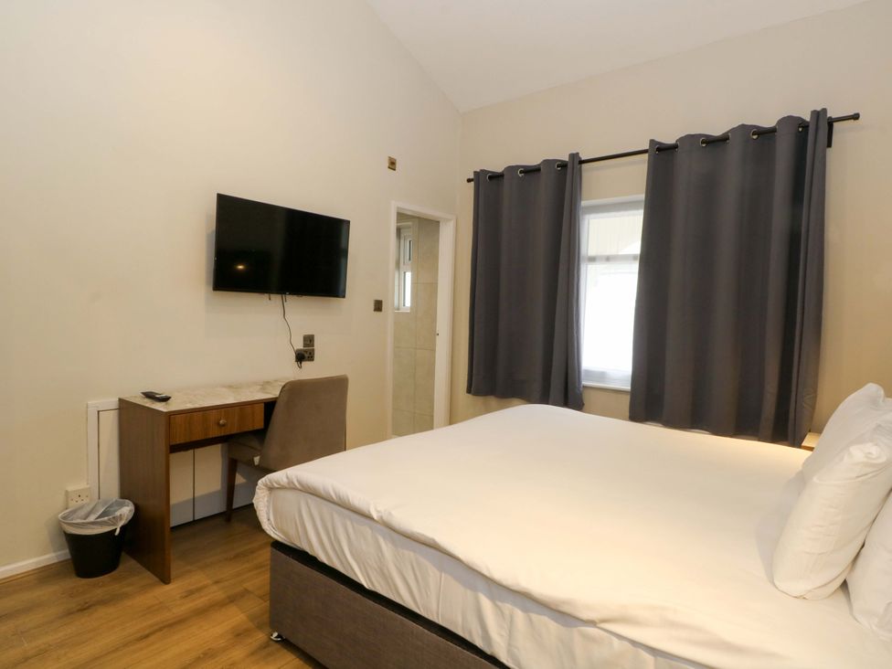 A bedroom with a bed and a television at 2 bed no.1 Chorley