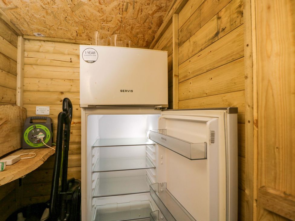 A refrigerator in a cabin at Bedouin Bell Tent in Woolton Hill