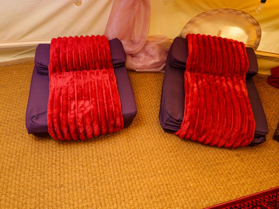 Two cushions on a rug at Bedouin Bell Tent in Woolton Hill