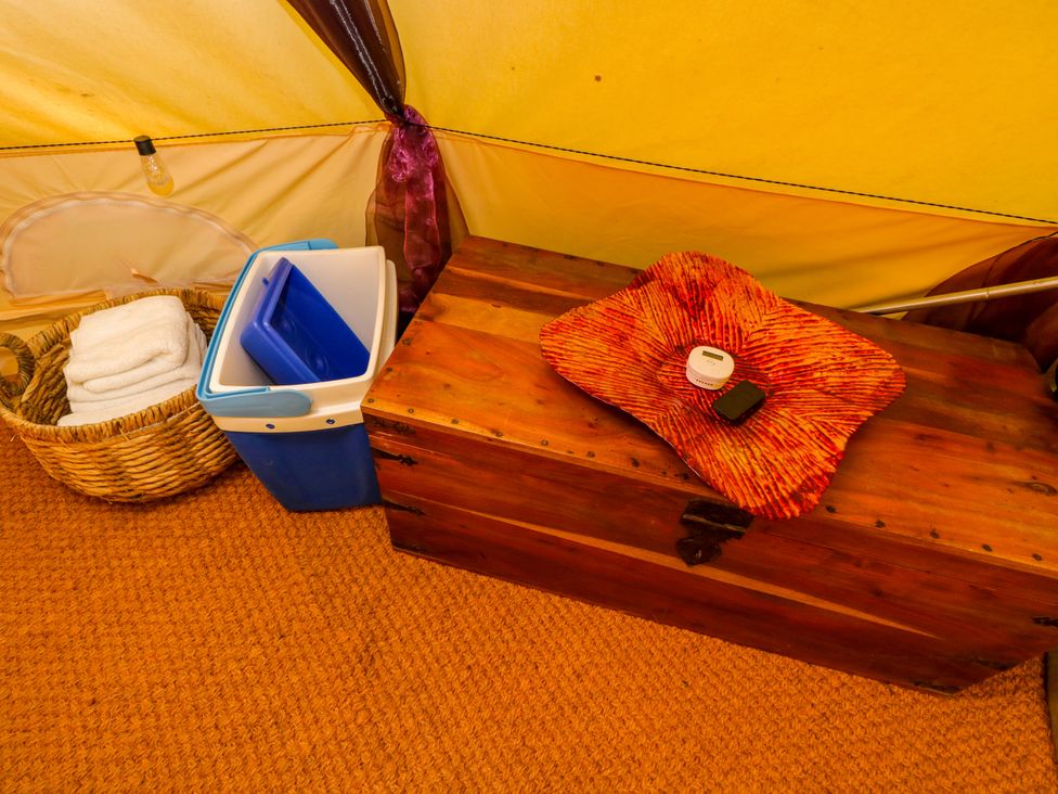 An indoor space with a wooden chest and a cooler at Bedouin Bell Tent in Woolton Hill