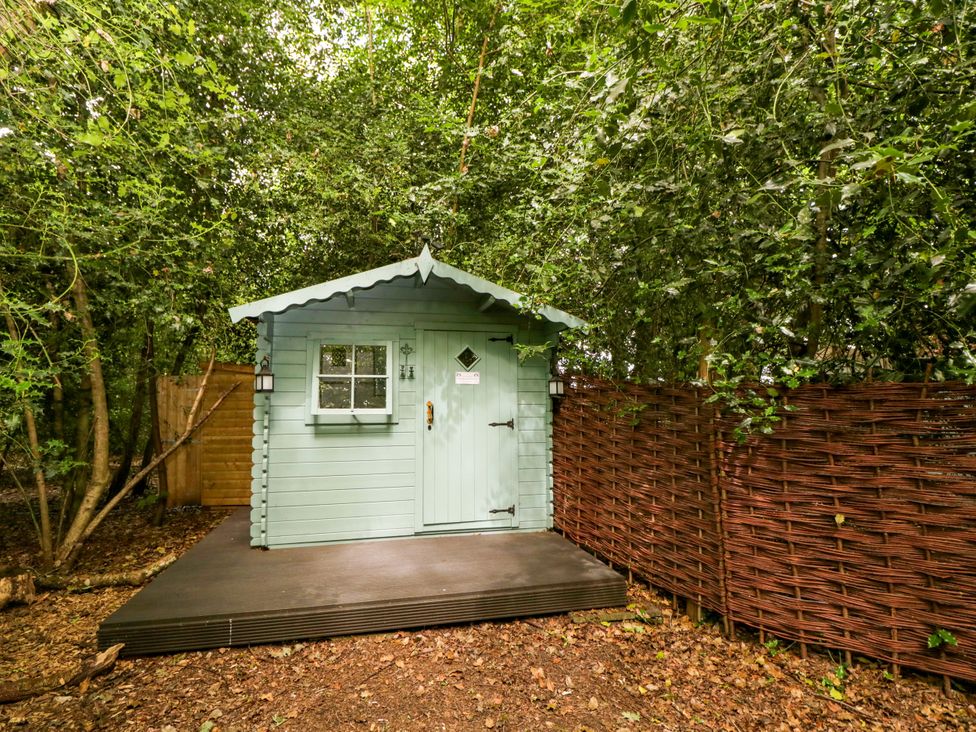 A shed surrounded by trees at Bedouin Bell Tent in Woolton Hill