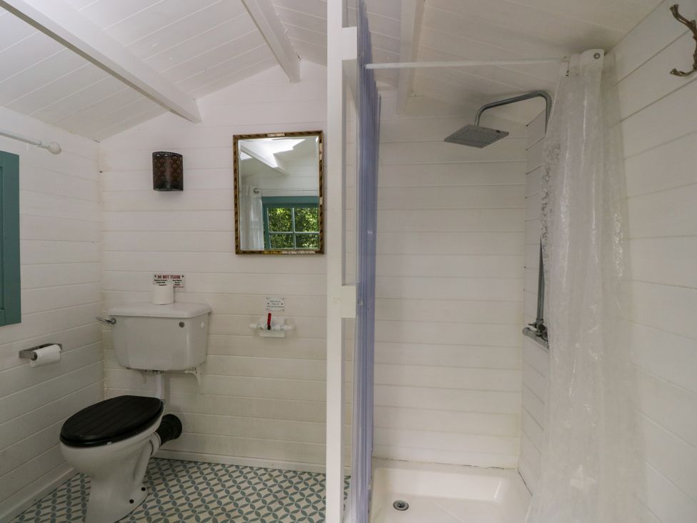 A bathroom with a shower and toilet at Bedouin Bell Tent in Woolton Hill