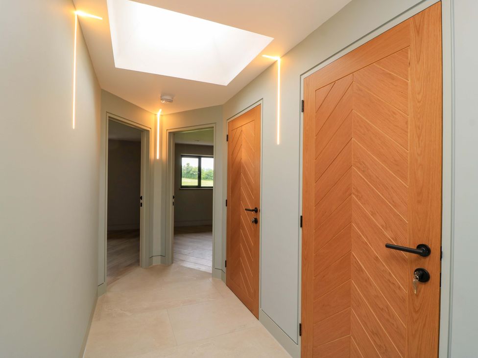 A hallway with doors and a skylight at The Cozy Sow in Yeovil