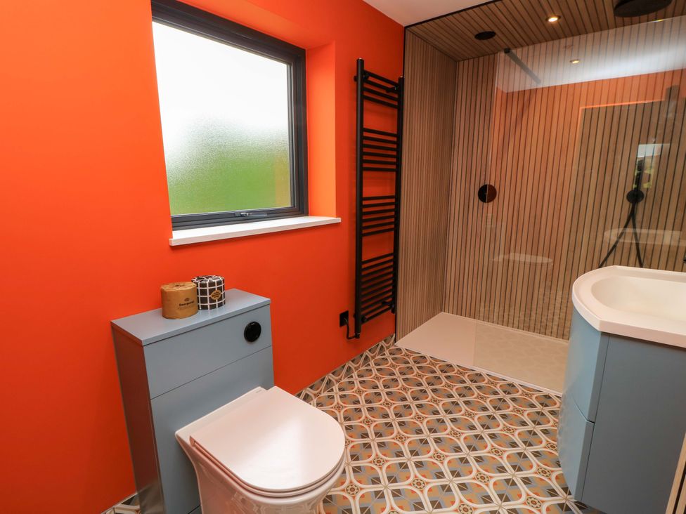 A bathroom featuring a toilet, sink, and shower at The Cozy Sow in Yeovil