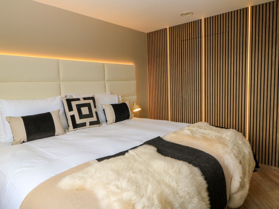 A bedroom with a bed and cushions at The Cozie Sow in Galhampton