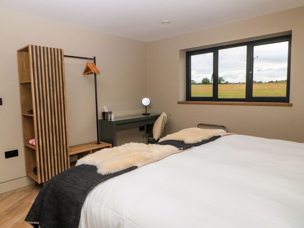 A bedroom with a bed and desk at The Cozie Sow in Galhampton