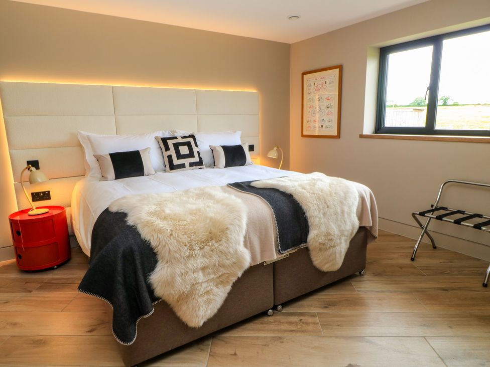 A bedroom with a bed and bedside table at The Cozie Sow in Galhampton