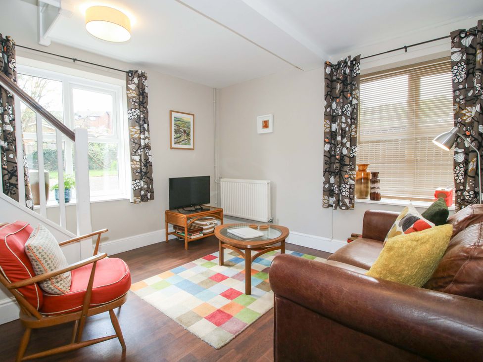 A living room with a couch and coffee table at Little Pentwyn in Clyro