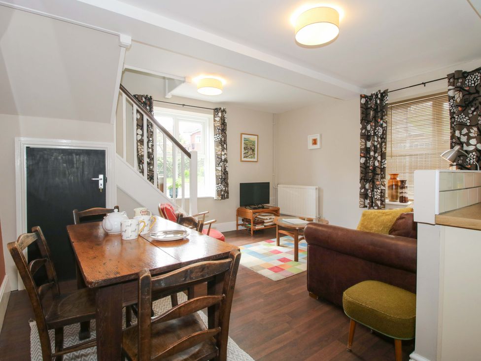 A dining room with a table and chairs at Little Pentwyn in Clyro