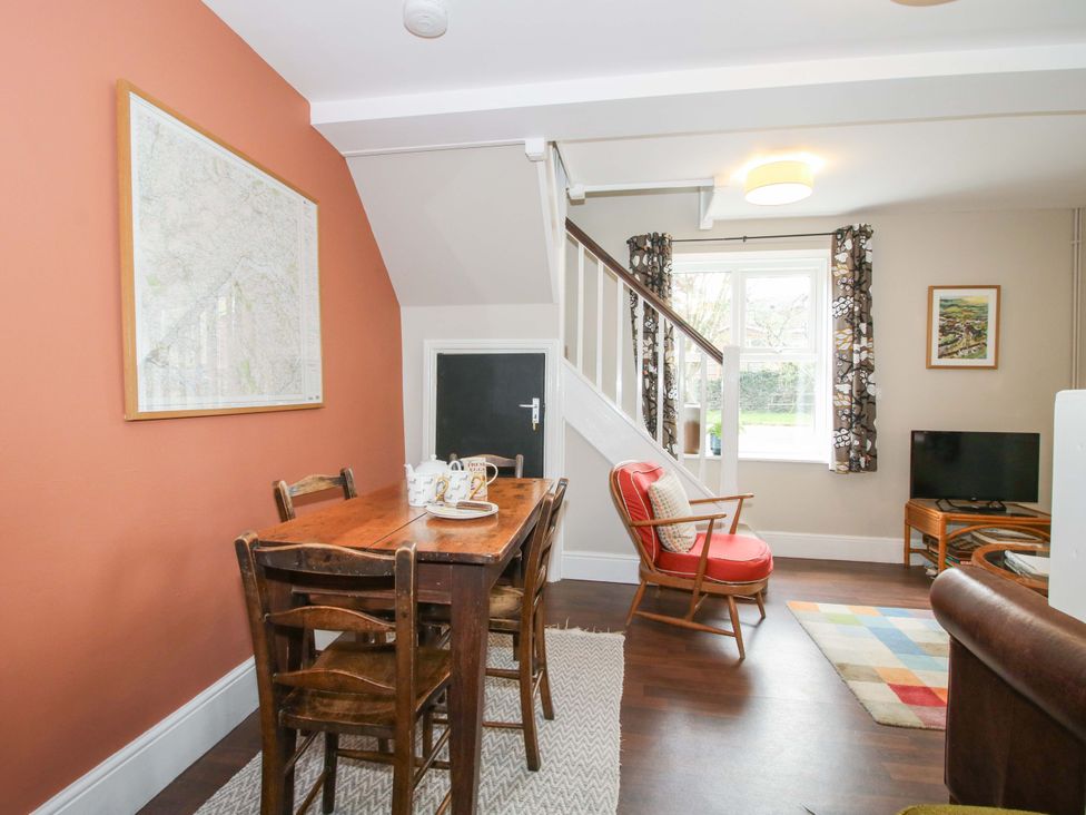 A dining room with a table and chairs at Little Pentwyn in Clyro