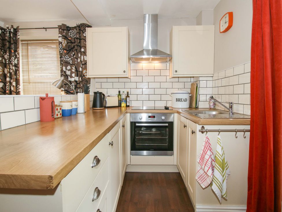 A kitchen with a counter, oven, and sink at Little Pentwyn in Clyro
