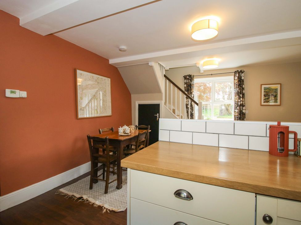 A dining room with a table and chairs at Little Pentwyn in Clyro