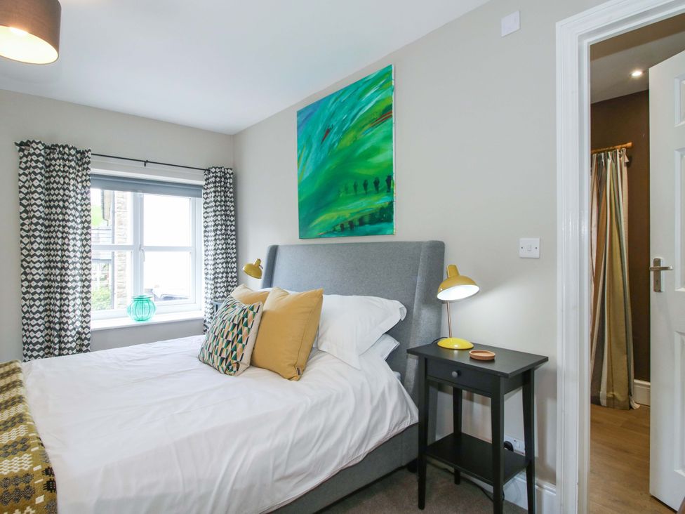 A bedroom with a bed and a bedside table at Little Pentwyn in Clyro