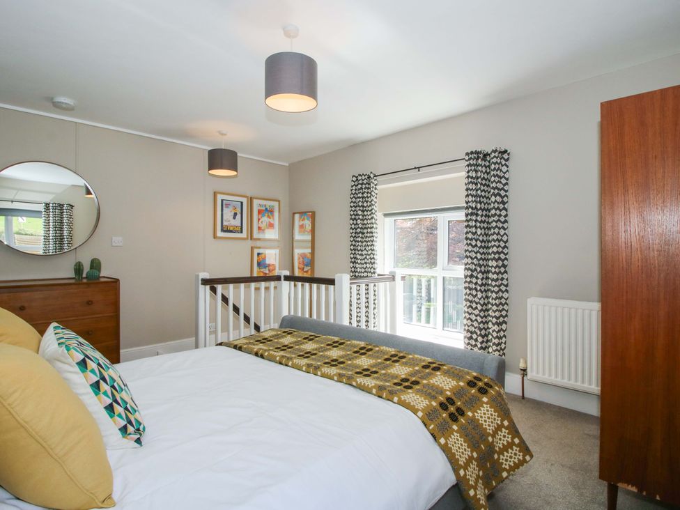 A bedroom with a bed and dresser at Little Pentwyn Clyro