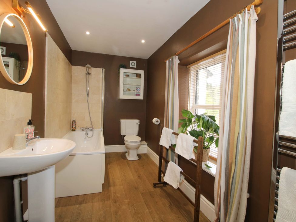 A bathroom with bath and shower at Little Pentwyn in Clyro