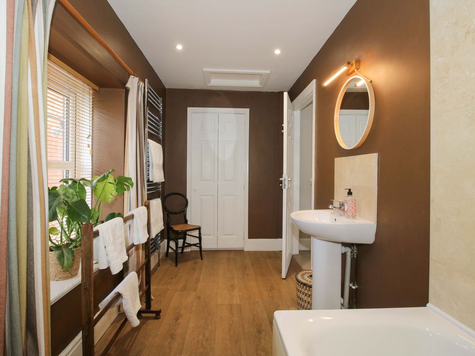 A bathroom with a bathtub and sink at Little Pentwyn in Clyro