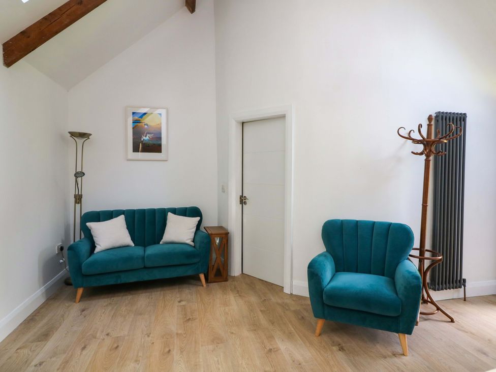 A living room with a sofa and chair at The Mews @ Derrybawn in Laragh, County Wicklow