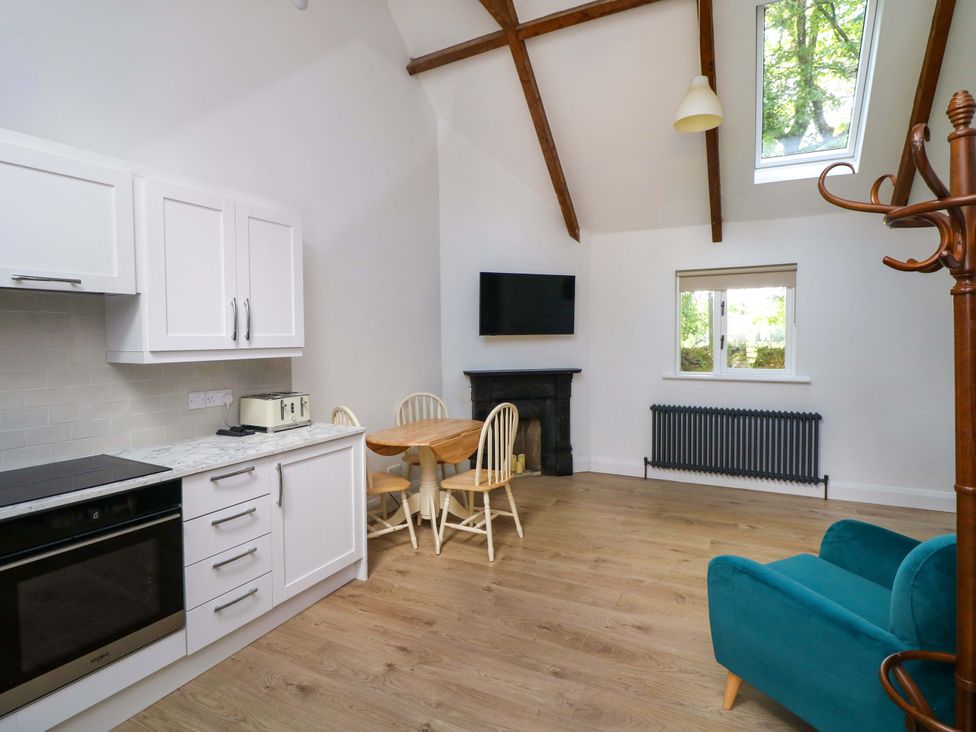 A kitchen with a table and chairs at The Mews @ Derrybawn in Laragh, County Wicklow