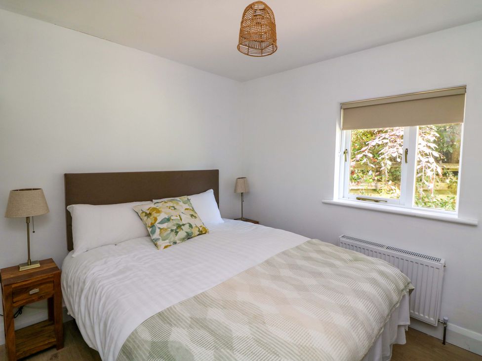 A bedroom with a bed and window at The Mews @ Derrybawn Laragh, County Wicklow
