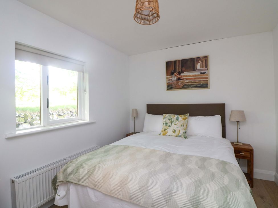 A bedroom with a bed and window at The Mews @ Derrybawn, Laragh, County Wicklow