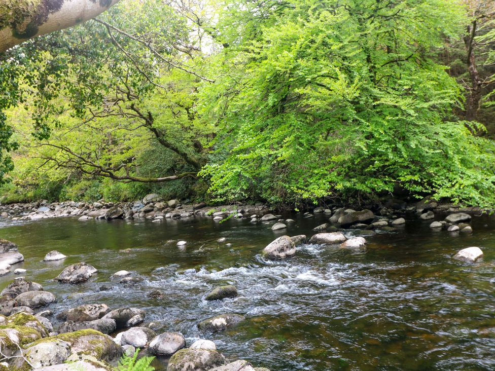 A river with rocks and trees at The Mews @ Derrybawn Laragh, County Wicklow