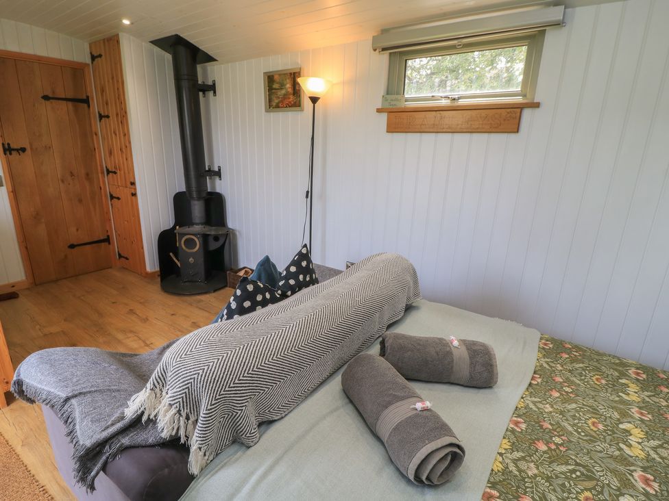 A bedroom with a bed and towels at Bramleys Williton