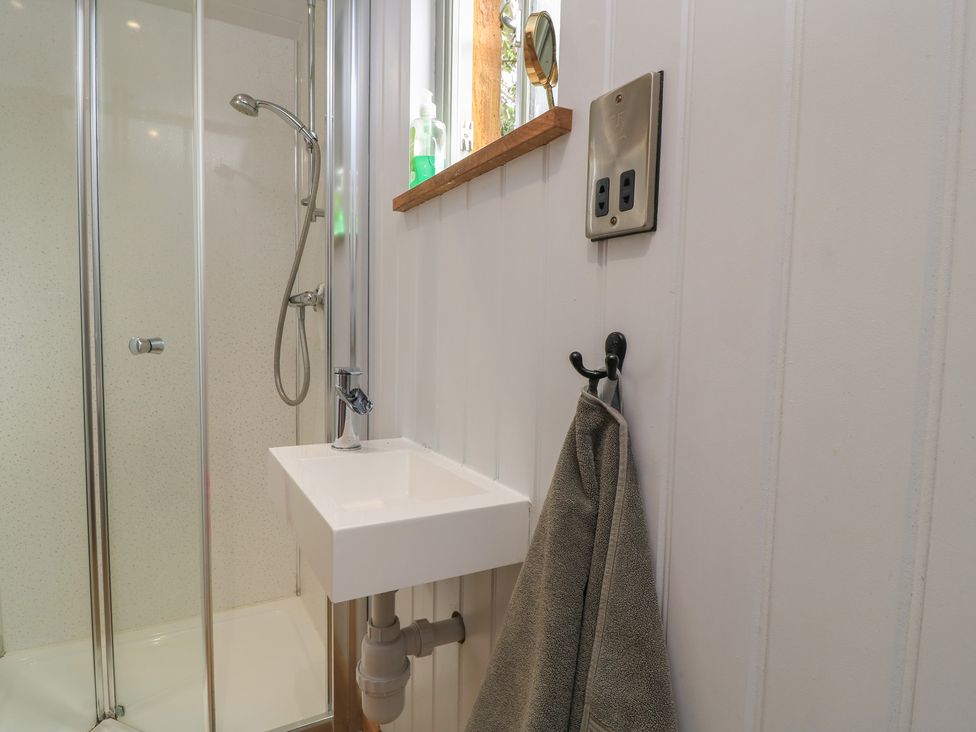 A bathroom with a shower and a sink at Bramleys in Williton