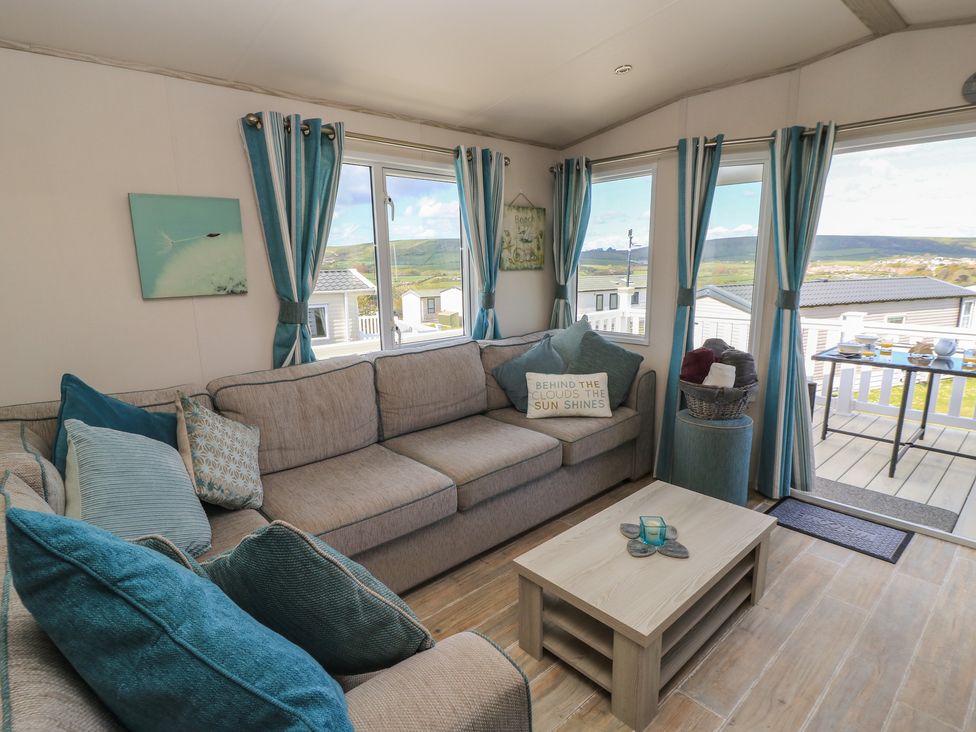 A living room with a sofa and coffee table at Swanny View in Swanage