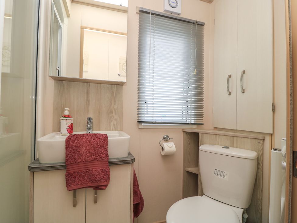A bathroom with a sink and toilet at Swanny View in Swanage