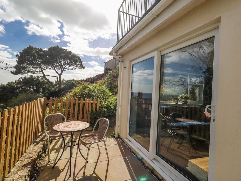 An outdoor area with a table and chairs at Flat B in Bournemouth