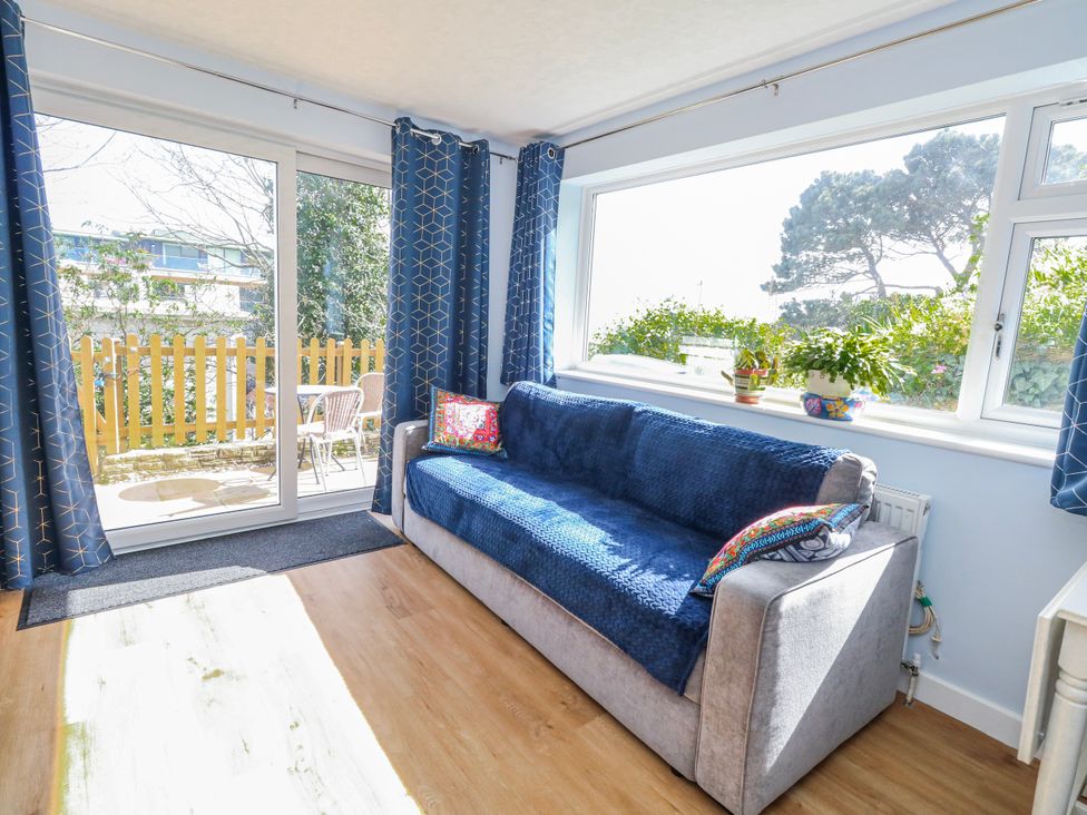 A snug with a sofa and curtains at Flat B in Bournemouth