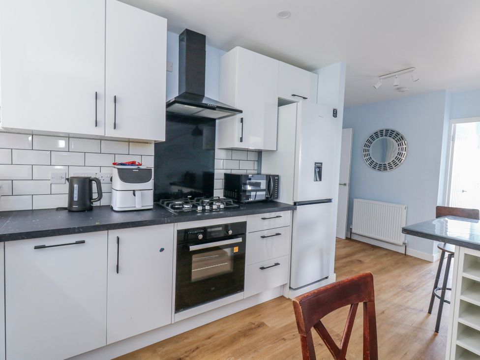 A kitchen with cabinets and appliances at Flat B in Bournemouth