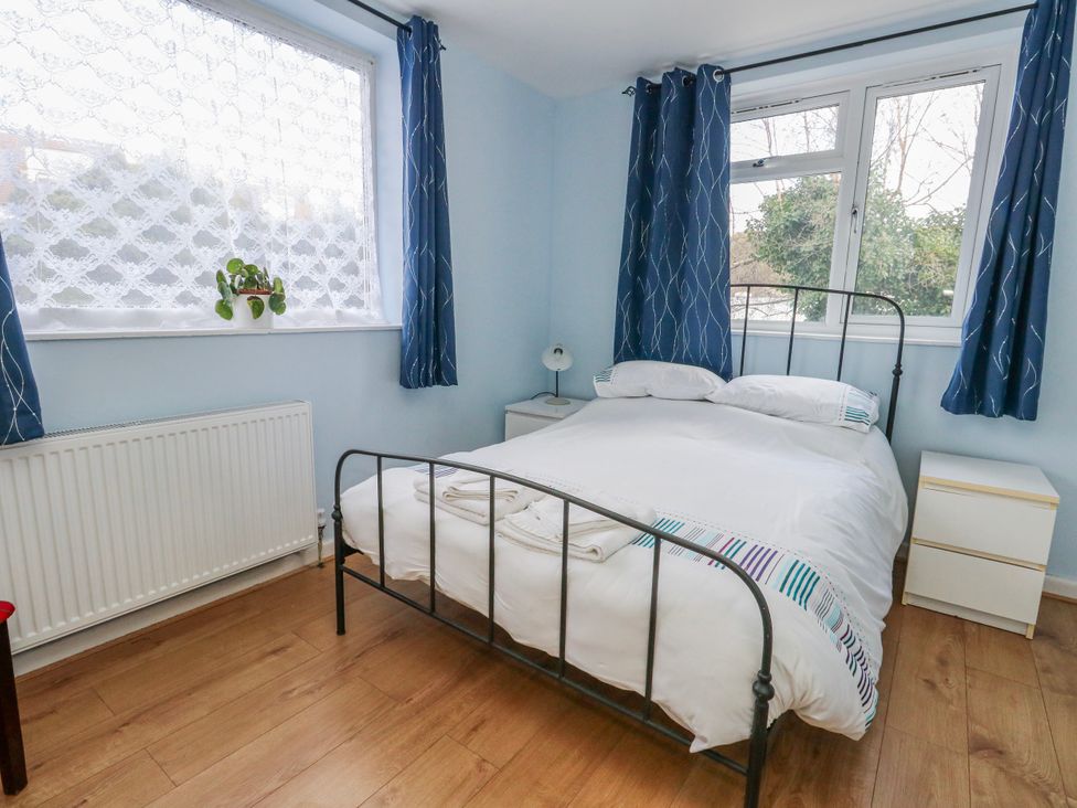 A bedroom with a bed and window at Flat B in Bournemouth