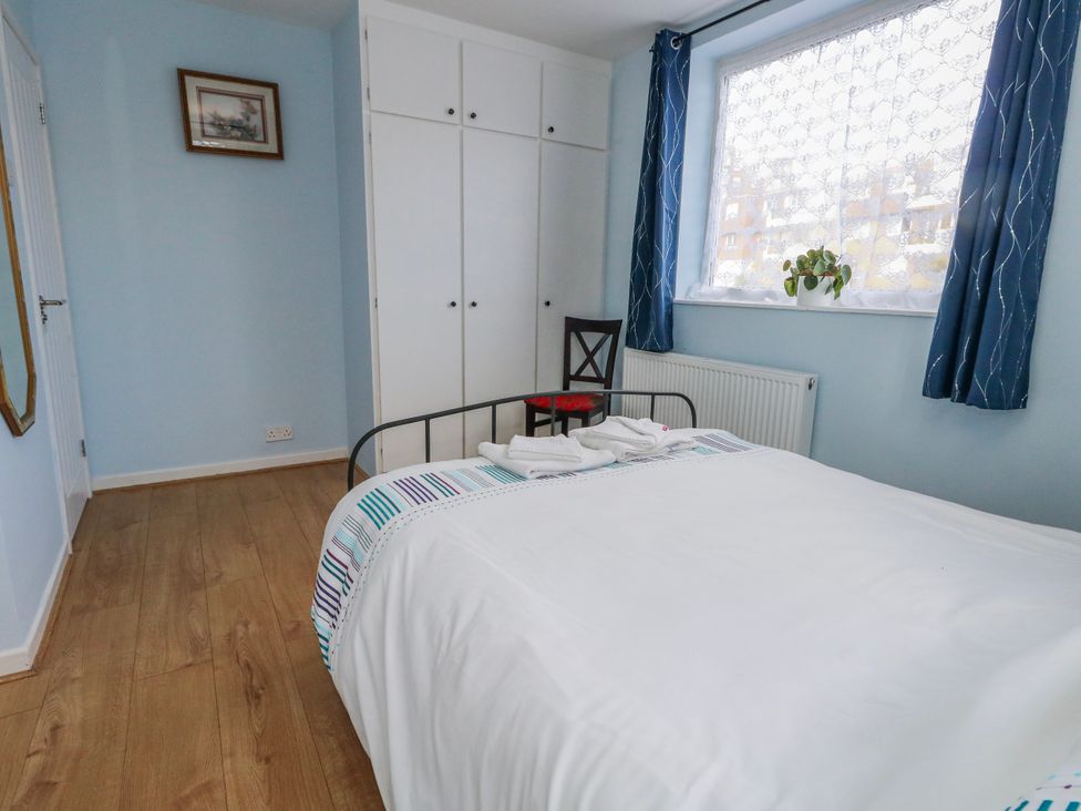 A bedroom with a bed and wardrobe at Flat B in Bournemouth