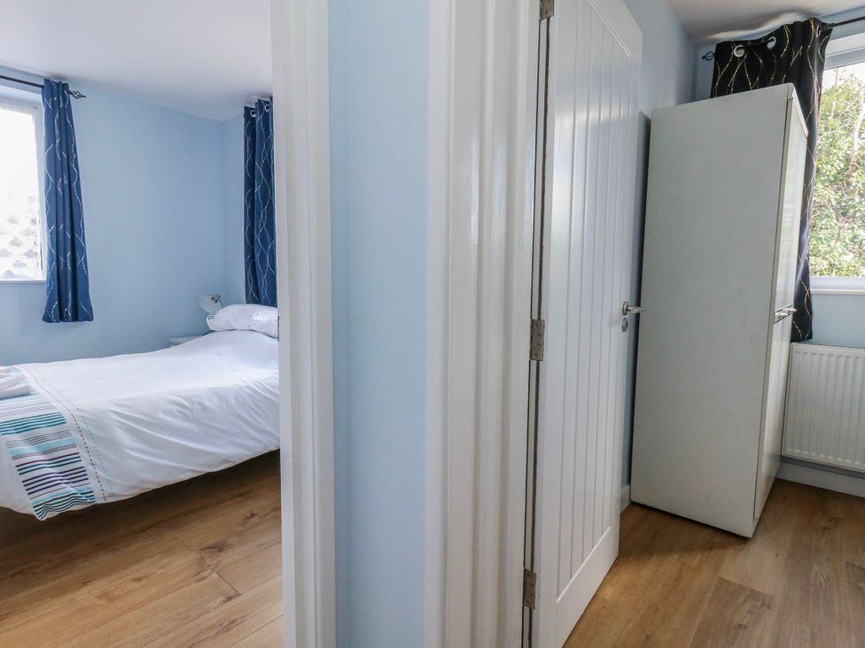 A bedroom with a bed and wardrobe at Flat B in Bournemouth