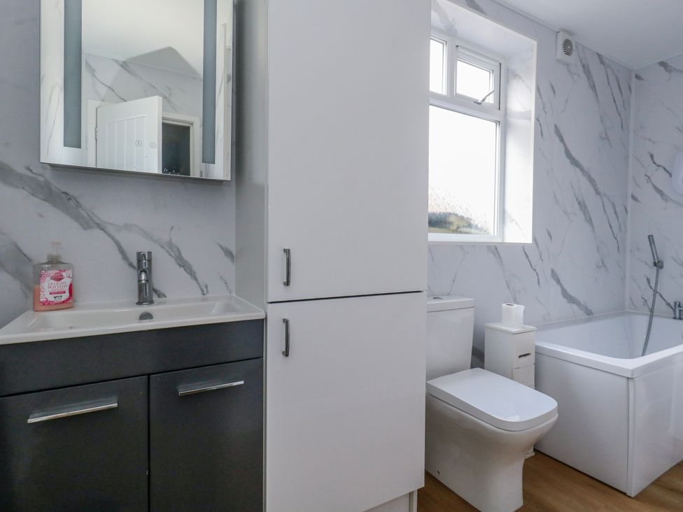 A bathroom with a sink and toilet at Flat B in Bournemouth
