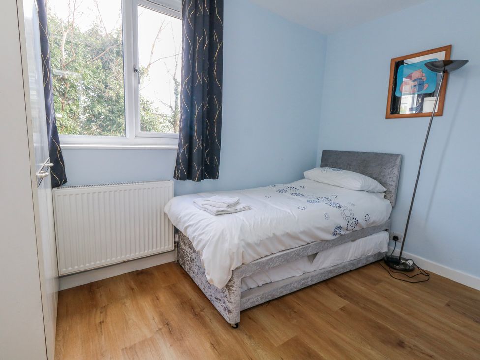 A bedroom with a bed and a window at Flat B in Bournemouth
