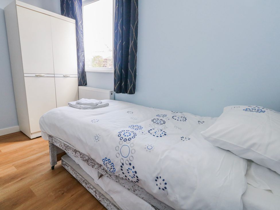 A bedroom with a bed and wardrobe at Flat B in Bournemouth