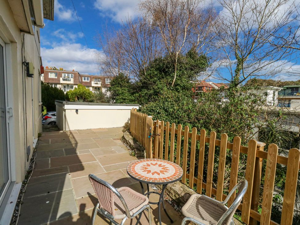 An outdoor space with a table and chairs at Flat B in Bournemouth